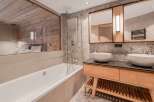 Experience luxury in this stunning bathroom, featuring a modern design with a touch of rustic charm.