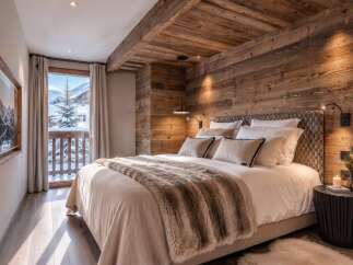 Experience ultimate comfort in this luxurious mountain retreat bedroom, featuring a plush king-sized bed adorned with a cozy fur throw.