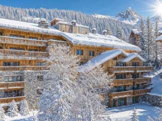 Experience luxury mountain living in this stunning chalet, nestled amidst snow-covered pines with breathtaking alpine views.