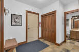 Step into this inviting entryway, featuring a neutral-toned door and a convenient closet.