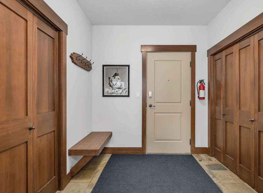 Step into this inviting entryway, showcasing beautiful wooden doors and trim that exude warmth and elegance.