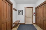 Step into this inviting entryway, showcasing beautiful wooden doors and trim that exude warmth and elegance.