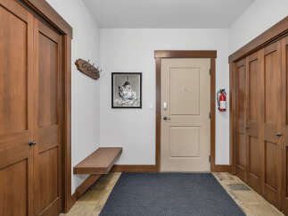 Step into this inviting entryway, showcasing beautiful wooden doors and trim that exude warmth and elegance.