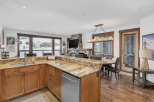 This stunning kitchen boasts a beautiful granite countertop and stainless steel appliances, perfect for preparing meals.