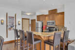 This stunning kitchen boasts a beautiful granite countertop and a breakfast bar with stylish seating, perfect for entertaining.