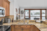 This stunning kitchen boasts beautiful granite countertops and custom cabinetry, creating an inviting space for culinary endeavors.