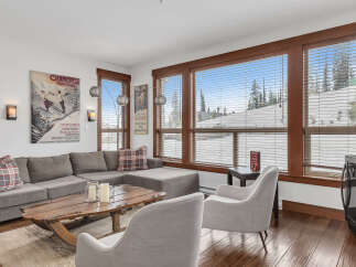 This cozy living room boasts a comfortable sectional sofa, perfect for relaxing after a day on the slopes.