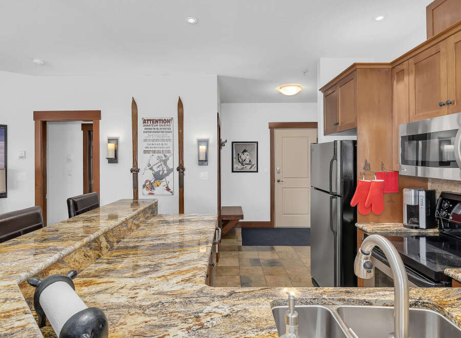 This stunning kitchen boasts a beautiful granite countertop, perfect for meal preparation and entertaining.