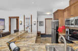 This stunning kitchen boasts a beautiful granite countertop, perfect for meal preparation and entertaining.