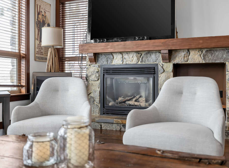 This cozy living space features a stunning stone fireplace, perfect for creating a warm and inviting atmosphere.