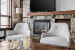 This cozy living space features a stunning stone fireplace, perfect for creating a warm and inviting atmosphere.