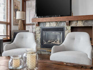 This cozy living space features a stunning stone fireplace, perfect for creating a warm and inviting atmosphere.