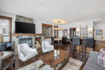 This stunning property boasts a cozy living room with a stone fireplace and a large flat-screen TV, perfect for relaxing evenings.
