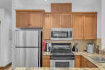 This stunning kitchen boasts stainless steel appliances, including a refrigerator, microwave, and oven.