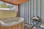 Relax and unwind in this luxurious outdoor space featuring a hot tub, perfect for soaking after a day on the slopes.