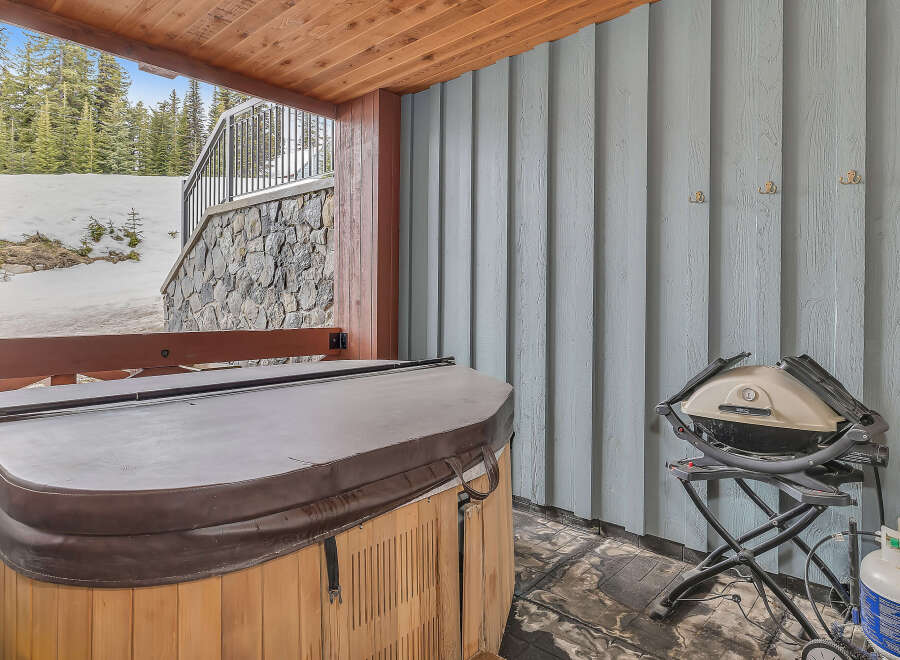 Relax and unwind in this luxurious outdoor space, complete with a hot tub and a grill.