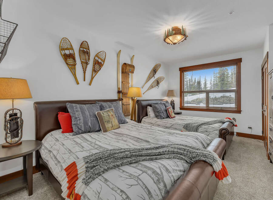 This cozy bedroom features two comfortable beds with stylish bedding and decorative pillows.