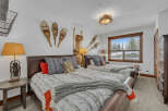 This cozy bedroom features two comfortable beds with stylish bedding and decorative pillows.