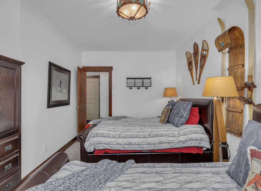 This cozy bedroom features a rustic ski lodge theme, perfect for a mountain getaway.