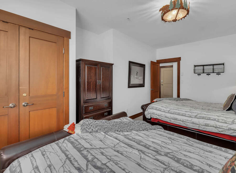 This cozy bedroom features two comfortable beds, perfect for guests or family.