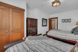 This cozy bedroom features two comfortable beds, perfect for guests or family.