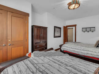 This cozy bedroom features two comfortable beds, perfect for guests or family.