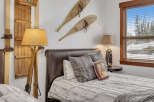 This cozy bedroom features rustic decor with wooden accents and a comfortable bed.