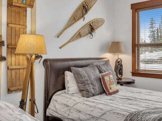 This cozy bedroom features rustic decor with wooden accents and a comfortable bed.