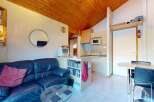 Discover this charming property featuring a cozy living area with a comfortable blue leather sofa and a stylish glass coffee table.