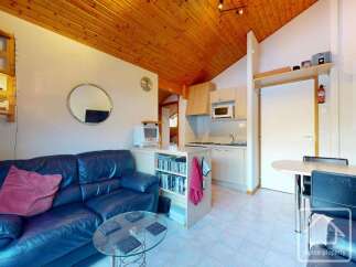Discover this charming property featuring a cozy living area with a comfortable blue leather sofa and a stylish glass coffee table.
