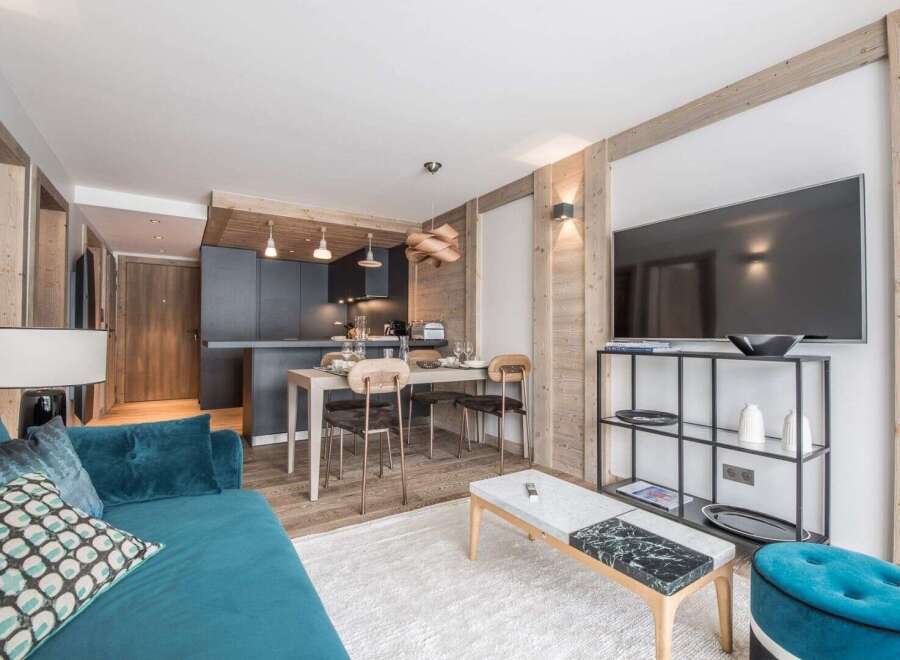 Discover modern living in this stylish apartment, featuring a sleek kitchen and a cozy living area.