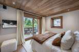 Experience luxury in this stunning bedroom featuring a cozy ambiance and elegant design.