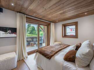 Experience luxury in this stunning bedroom featuring a cozy ambiance and elegant design.