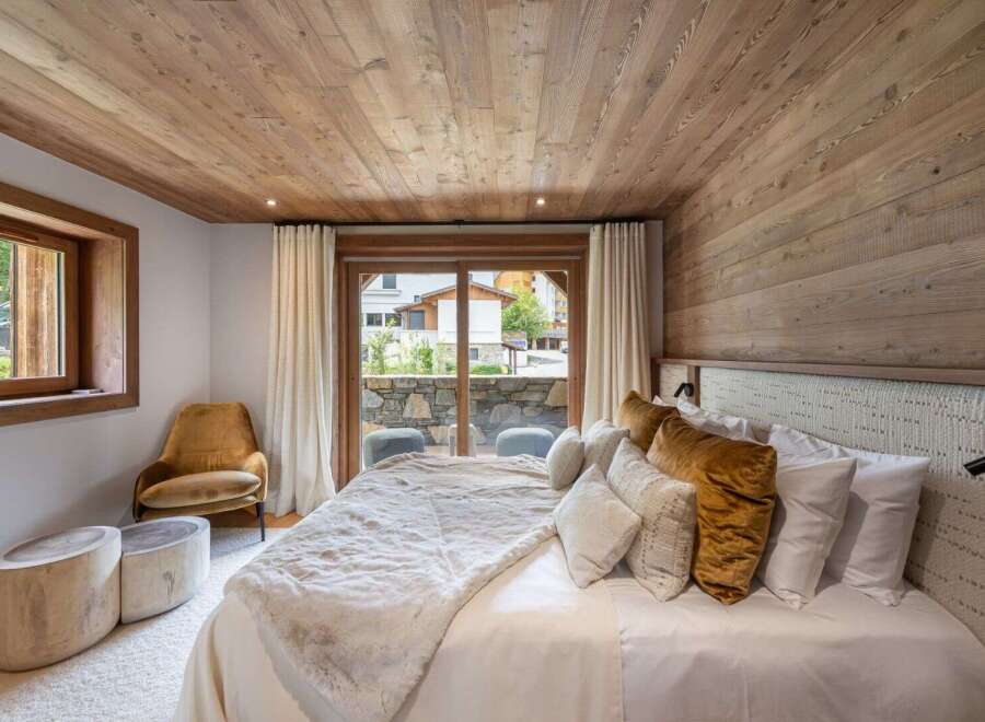 Experience luxury in this stunning bedroom featuring a cozy ambiance.