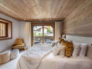 Experience luxury in this stunning bedroom featuring a cozy ambiance.