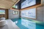 This luxurious indoor pool offers a serene escape with its stunning design and features.
