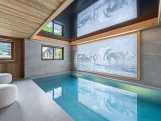 This luxurious indoor pool offers a serene escape with its stunning design and features.