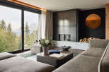 Experience luxury living in this stunning property, featuring breathtaking mountain views framed by expansive windows.