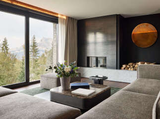 Experience luxury living in this stunning property, featuring breathtaking mountain views framed by expansive windows.