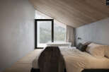 Experience luxury living in this stunning bedroom with breathtaking mountain views.