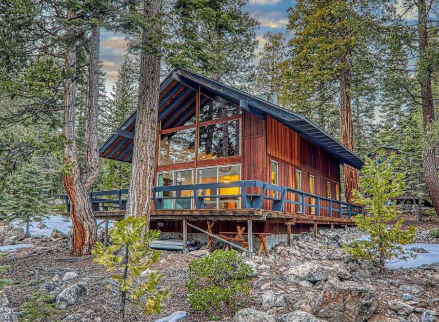 Nestled amidst towering trees, this stunning cabin offers a serene escape.