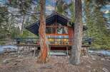 Nestled in a serene forest setting, this charming cabin offers a perfect blend of rustic charm and modern comfort.