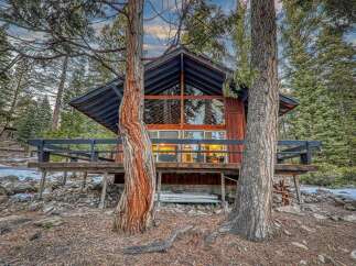 Nestled in a serene forest setting, this charming cabin offers a perfect blend of rustic charm and modern comfort.