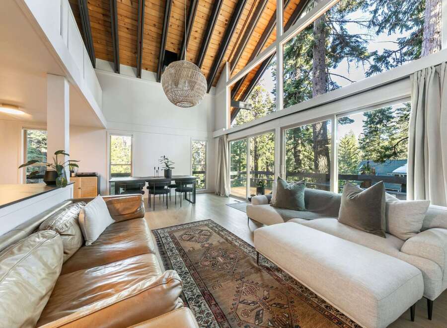 Experience luxury living in this stunning property, featuring a spacious open-concept design with soaring ceilings and expansive windows.