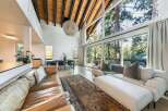 Experience luxury living in this stunning property, featuring a spacious open-concept design with soaring ceilings and expansive windows.