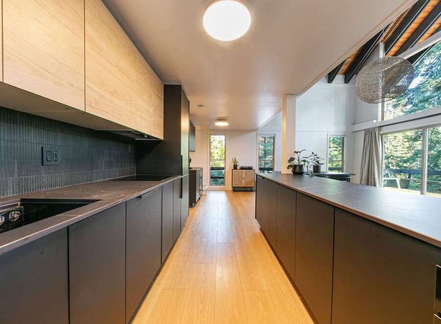This stunning kitchen boasts a modern design with sleek cabinetry and a spacious layout, perfect for culinary enthusiasts.