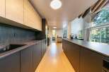 This stunning kitchen boasts a modern design with sleek cabinetry and a spacious layout, perfect for culinary enthusiasts.
