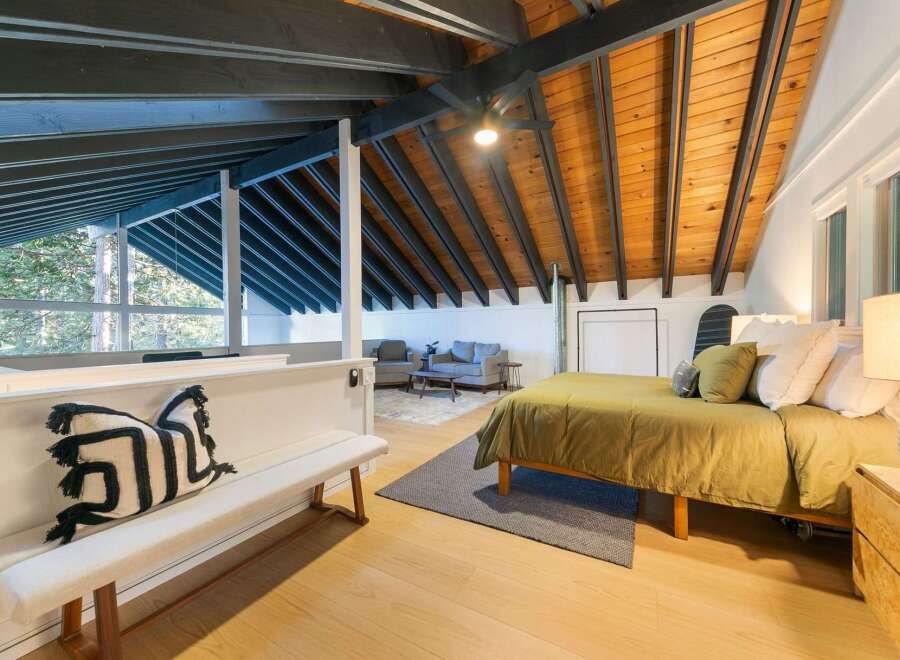Discover the charm of this stunning property, featuring a beautifully designed bedroom with exposed wooden beams and a cozy ambiance.