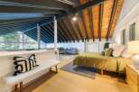 Discover the charm of this stunning property, featuring a beautifully designed bedroom with exposed wooden beams and a cozy ambiance.