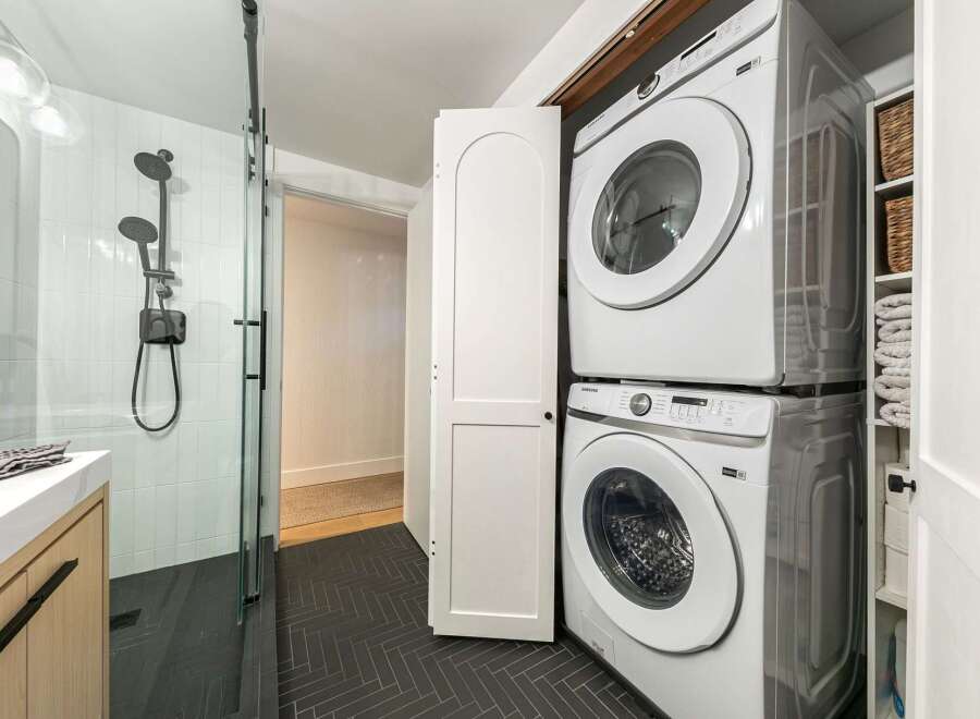 Step into a modern oasis with this stunning property! Featuring a sleek, tiled shower and a convenient stacked washer and dryer, this home combines style and functionality.